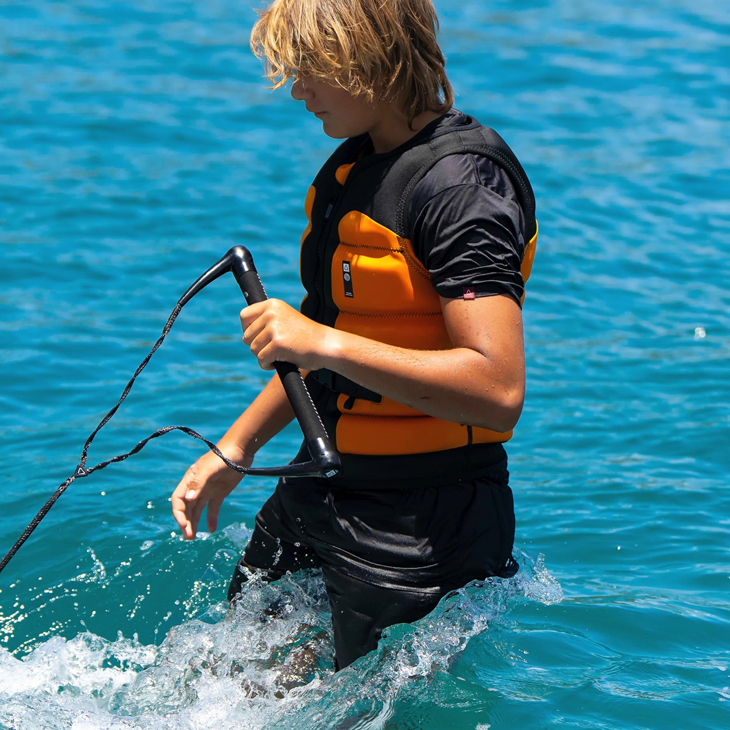 Follow Global Youth Life Jacket - Black/Orange in use