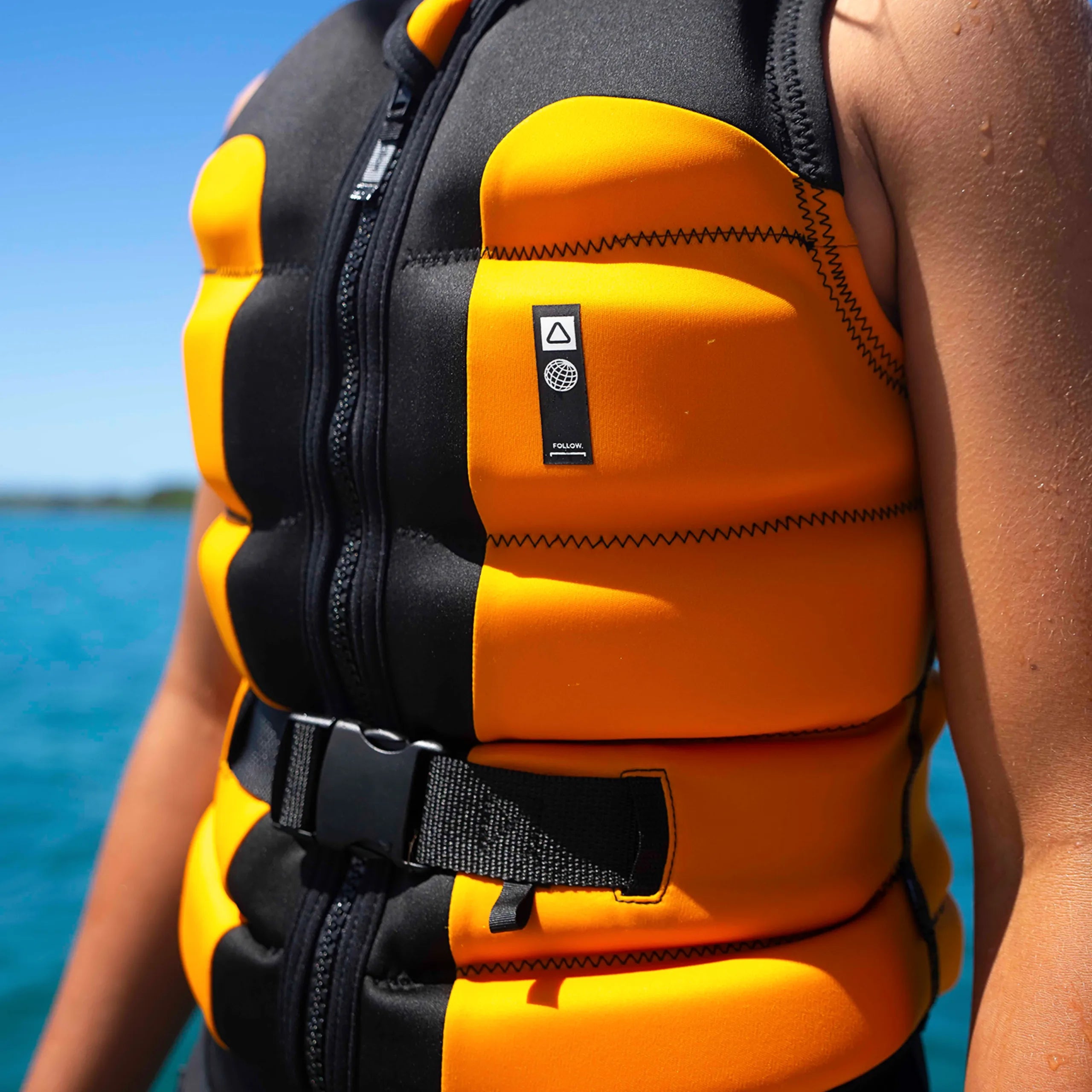 Follow Global Youth Life Jacket - Black/Orange in use